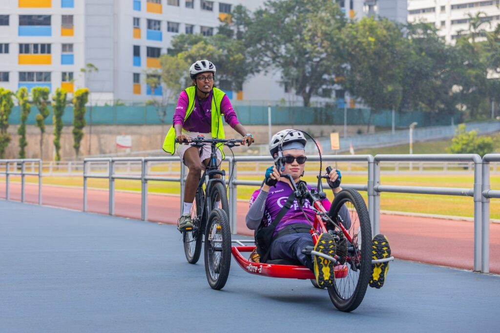 Coach Yvette at Community Training Session Cycling Along with Handcycle Athlete Zi Yong 
