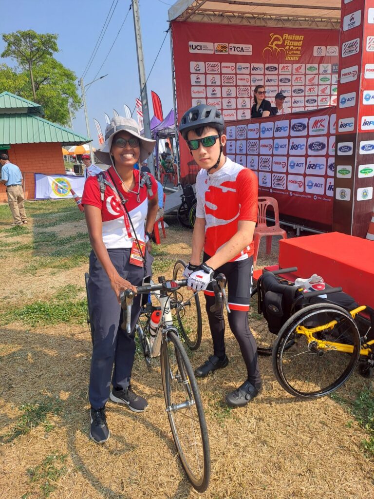 Coach Yvette with Tricycle Athlete Sebastian getting ready to race at the 13th Asian Para Road Cycling Championship in Thailand 