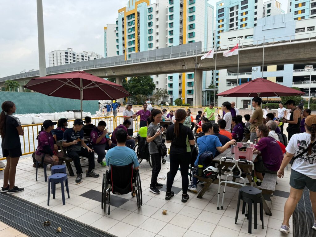 Coach Devi debriefing athletes after community training session